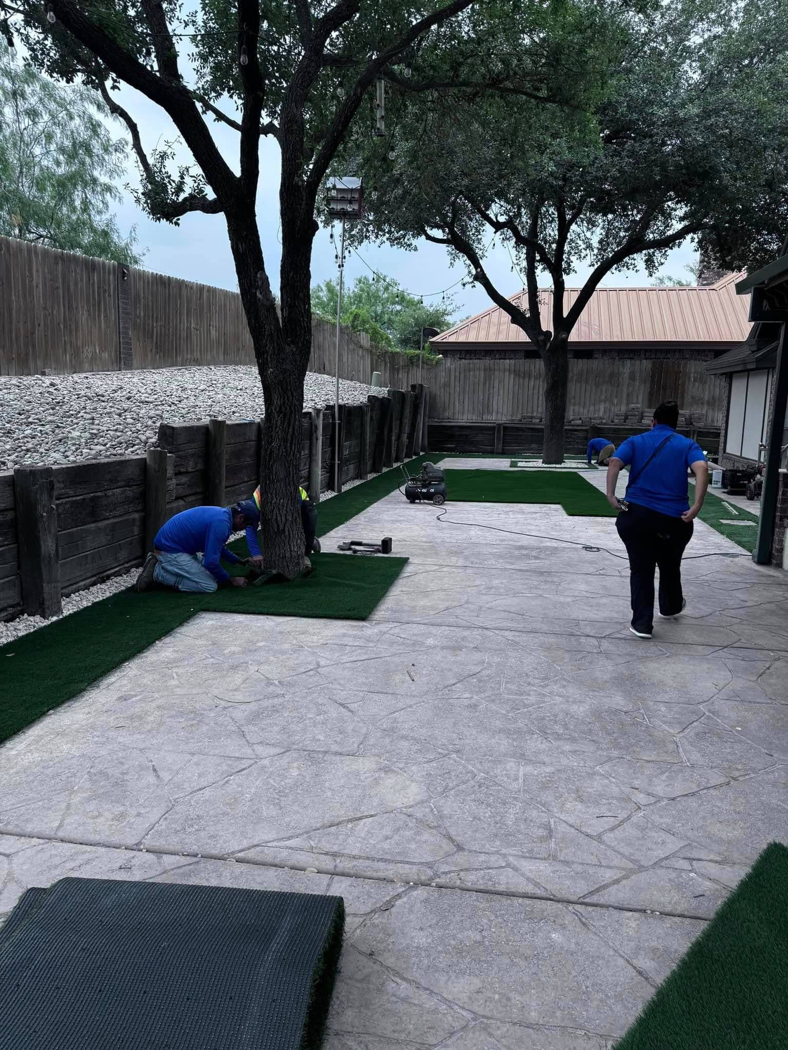 The Southern Gardens crew installing artificial turf